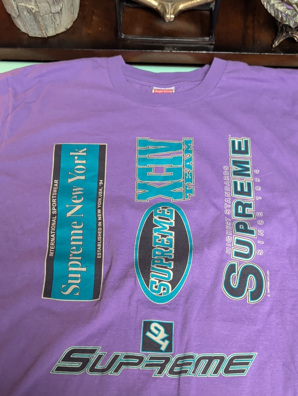 Supreme Purple Tee with Teal & Black Multi-Logo Print